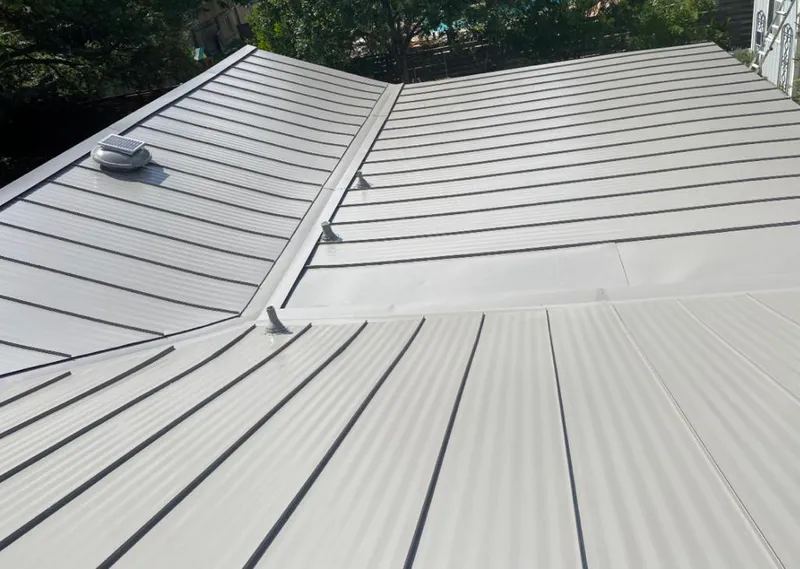 Solar attic fan installed on a metal roof for Roof Ventilation in Tarrytown